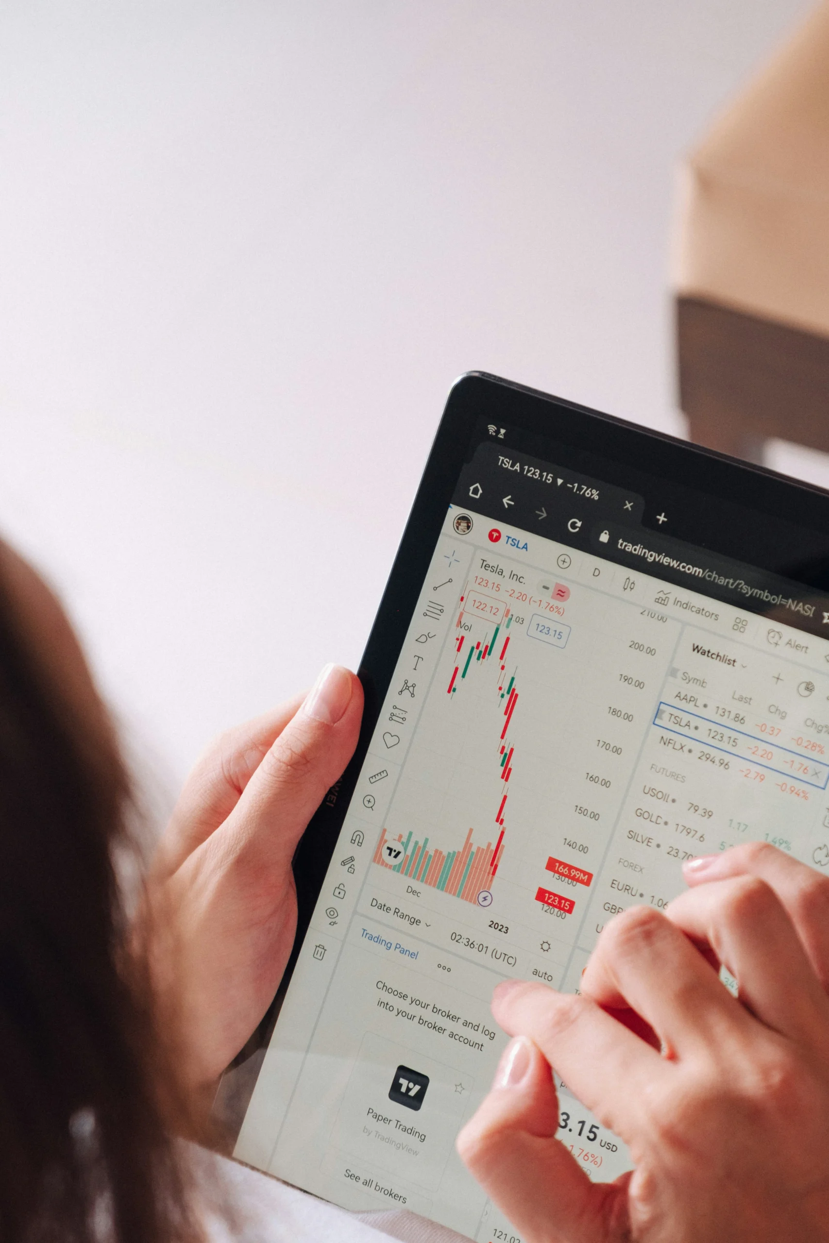 a girl holding an ipad that's showing charts